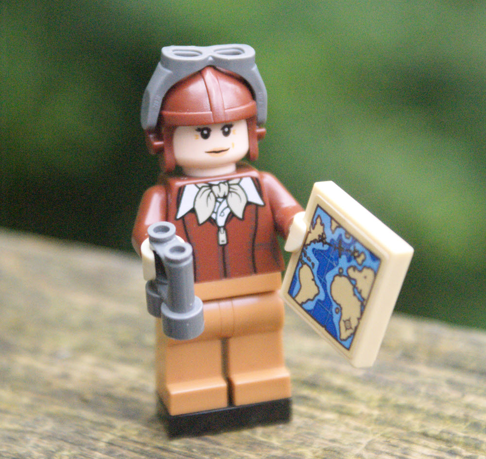 Lego character holding a map and binoculars